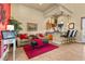 Comfortable living room with plush seating, a red accent wall, and a wet bar, perfect for entertaining at 670 Du Fort Ave, Henderson, NV 89002