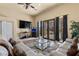 Living room features tile floor, doors to patio, and comfortable seating at 670 Du Fort Ave, Henderson, NV 89002
