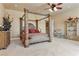Elegant main bedroom featuring a four-poster bed, sitting area, and custom storage at 670 Du Fort Ave, Henderson, NV 89002