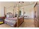 Comfortable main bedroom with seating area, four-poster bed, and ample natural light at 670 Du Fort Ave, Henderson, NV 89002