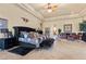 Large main bedroom with a tray ceiling, a decorative rug, and a seating area, offering a luxurious retreat at 670 Du Fort Ave, Henderson, NV 89002