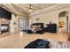 A spacious main bedroom featuring a stone fireplace, an elegant ceiling, and access to the outdoor space at 670 Du Fort Ave, Henderson, NV 89002