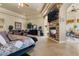 Comfortable main bedroom showcasing a stone fireplace, a large TV, and a plush seating area for relaxation at 670 Du Fort Ave, Henderson, NV 89002