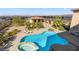 Backyard pool and hot tub combo with stone surround, waterfall feature, and desert landscape at 670 Du Fort Ave, Henderson, NV 89002