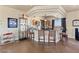 A stylish wet bar with elegant barstools, pendant lighting, and a display shelving for barware and decorative items at 670 Du Fort Ave, Henderson, NV 89002