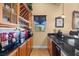 Stylish wet bar featuring wood cabinets, granite countertops, and ample storage for beverages and glassware at 670 Du Fort Ave, Henderson, NV 89002