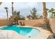 A backyard pool with a rock waterfall feature and palm trees at 71 Sea Holly Way, Henderson, NV 89074