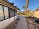 Home features a spacious backyard with a patio and walkway at 7588 Kalmalii Ave, Las Vegas, NV 89147