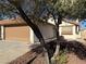 House exterior with a tree partially obscuring the view at 7588 Kalmalii Ave, Las Vegas, NV 89147