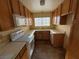 View of a kitchen with wood cabinets and white appliances at 7588 Kalmalii Ave, Las Vegas, NV 89147