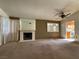 Spacious living room featuring a fireplace and a view into the kitchen at 7588 Kalmalii Ave, Las Vegas, NV 89147