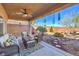 Covered patio with ceiling fan and stone landscaping create a relaxing backyard retreat at 7936 Tolberts Mill Dr, Las Vegas, NV 89131