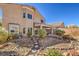 The exterior of this home features a stone landscaped backyard and covered patio at 7936 Tolberts Mill Dr, Las Vegas, NV 89131