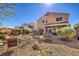 This backyard features stone landscaping, a covered patio, and a seating area at 7936 Tolberts Mill Dr, Las Vegas, NV 89131
