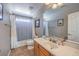 Bright bathroom features a shower-tub combo and framed mirror above a vanity sink at 7936 Tolberts Mill Dr, Las Vegas, NV 89131