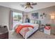 Cozy bedroom with large window, neutral walls, ceiling fan, and ample natural light at 7936 Tolberts Mill Dr, Las Vegas, NV 89131