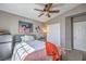 This cozy bedroom features a ceiling fan, a mini fridge, and a large window at 7936 Tolberts Mill Dr, Las Vegas, NV 89131