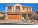 Inviting two-story home featuring a tile roof, neutral stucco, and a charming front yard at 7936 Tolberts Mill Dr, Las Vegas, NV 89131