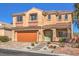 Traditional two-story home with a tile roof, an orange garage door, and a neutral-colored facade at 7936 Tolberts Mill Dr, Las Vegas, NV 89131