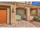 Inviting front entrance featuring a decorative door, tile walkway, and manicured landscaping at 7936 Tolberts Mill Dr, Las Vegas, NV 89131