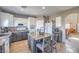 Open concept kitchen with an island, white and gray cabinets and tile flooring throughout at 7936 Tolberts Mill Dr, Las Vegas, NV 89131