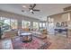 Bright living room featuring a comfortable sectional sofa, and large windows to let the sunshine in at 7936 Tolberts Mill Dr, Las Vegas, NV 89131