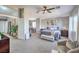 This main bedroom has neutral decor, a ceiling fan, and sitting area with carpet throughout at 7936 Tolberts Mill Dr, Las Vegas, NV 89131