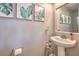 Tastefully decorated powder room with modern fixtures and a pedestal sink at 7936 Tolberts Mill Dr, Las Vegas, NV 89131