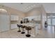 Bright kitchen with white cabinets, stainless steel appliances, and a convenient center island with bar stool seating at 830 Roaring Falls Ave, Henderson, NV 89052