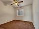 Cozy bedroom with neutral carpet and a ceiling fan at 840 Candido Garcia Ave, Henderson, NV 89015