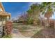 Landscaped backyard with grassy area and walkway at 8870 S Tenaya Way, Las Vegas, NV 89113