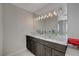 Double vanity bathroom with modern light fixtures and marble countertops at 8870 S Tenaya Way, Las Vegas, NV 89113