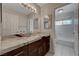 Bathroom with granite countertop, double sinks, and a separate tub and shower at 8870 S Tenaya Way, Las Vegas, NV 89113