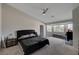 Bedroom with a king-size bed, large windows, and a ceiling fan at 8870 S Tenaya Way, Las Vegas, NV 89113