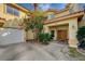 Front entrance with double doors and landscaping at 8870 S Tenaya Way, Las Vegas, NV 89113
