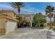Two-story house with a three-car garage and landscaping at 8870 S Tenaya Way, Las Vegas, NV 89113