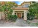 Front entrance with double doors and landscaping at 8870 S Tenaya Way, Las Vegas, NV 89113