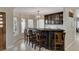 Elegant home bar with dark wood cabinetry and glass shelving at 8870 S Tenaya Way, Las Vegas, NV 89113
