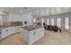 Island kitchen with granite countertops and white cabinets at 8870 S Tenaya Way, Las Vegas, NV 89113