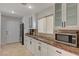 White kitchen cabinets and granite countertops at 8870 S Tenaya Way, Las Vegas, NV 89113