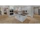 White kitchen with granite countertop island and stainless appliances at 8870 S Tenaya Way, Las Vegas, NV 89113