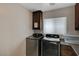 Laundry room with washer, dryer, and cabinets at 8870 S Tenaya Way, Las Vegas, NV 89113