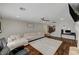 Living room with sectional sofa, hardwood floors and ceiling fan at 8870 S Tenaya Way, Las Vegas, NV 89113