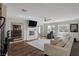 Spacious living room with hardwood floors, fireplace, and sectional sofa at 8870 S Tenaya Way, Las Vegas, NV 89113