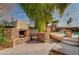 Outdoor kitchen with built-in grill and fireplace at 8870 S Tenaya Way, Las Vegas, NV 89113