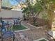 Relaxing backyard with stone landscaping, decorative rocks, and metal garden furniture at 9022 Sosa Creek Ave, Las Vegas, NV 89149