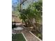 Zen garden featuring desert landscaping, stone features, and black metal outdoor furniture at 9022 Sosa Creek Ave, Las Vegas, NV 89149