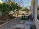Zen backyard with desert landscaping, stone pathways, and comfortable metal seating at 9022 Sosa Creek Ave, Las Vegas, NV 89149