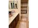 Well-lit bathroom featuring a dual sink vanity and shower with a striped curtain at 9022 Sosa Creek Ave, Las Vegas, NV 89149