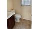 Small bathroom with tile flooring, toilet and cabinet with sink at 9022 Sosa Creek Ave, Las Vegas, NV 89149